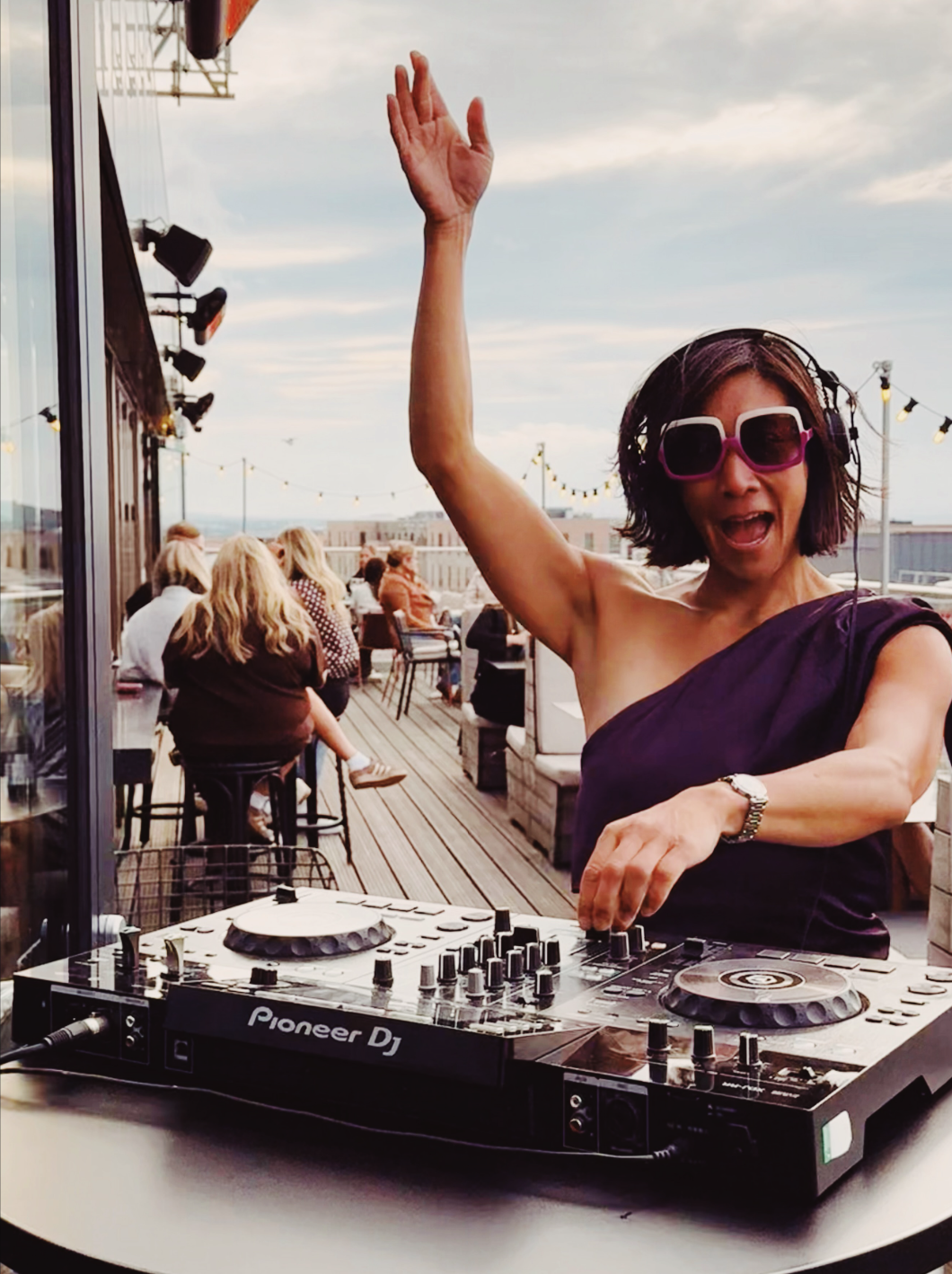 DJ Lu on the decks at a rooftop event